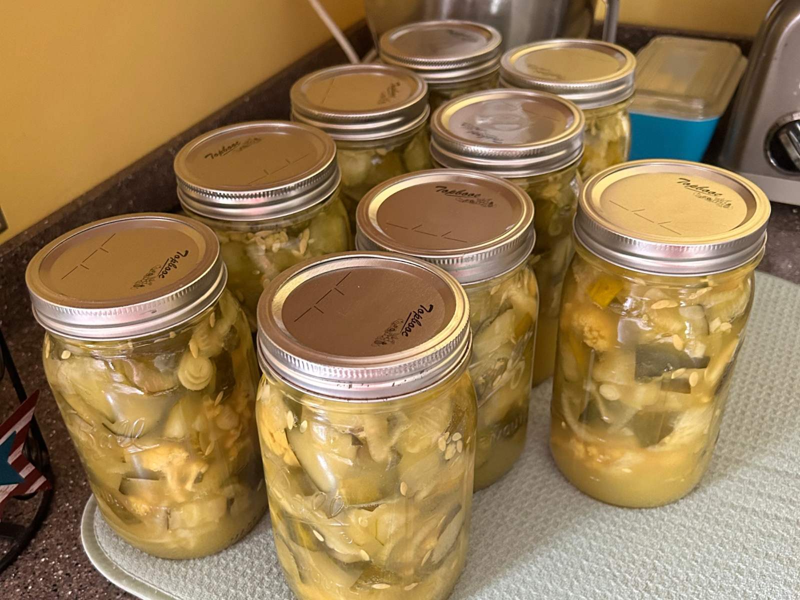 Jars of homemade pickles cooling on the counter
