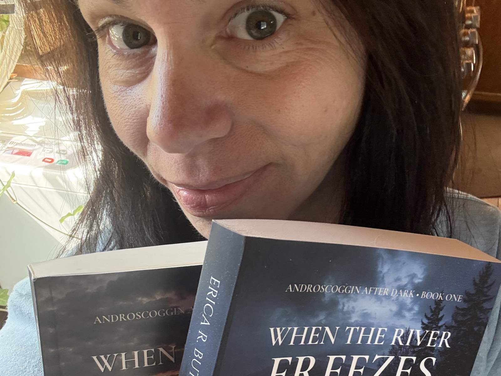 Erica holding her novel, When the River Freezes