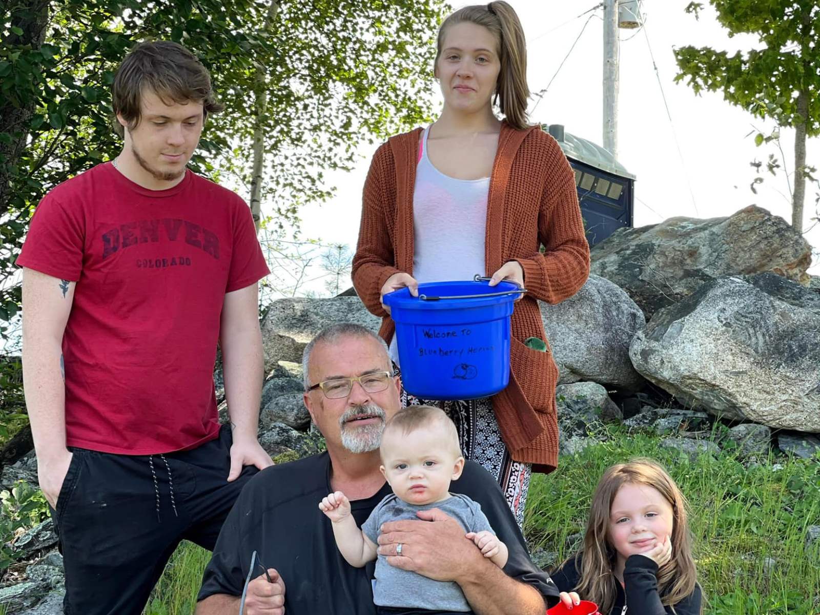 The family with blueberry picking buckets