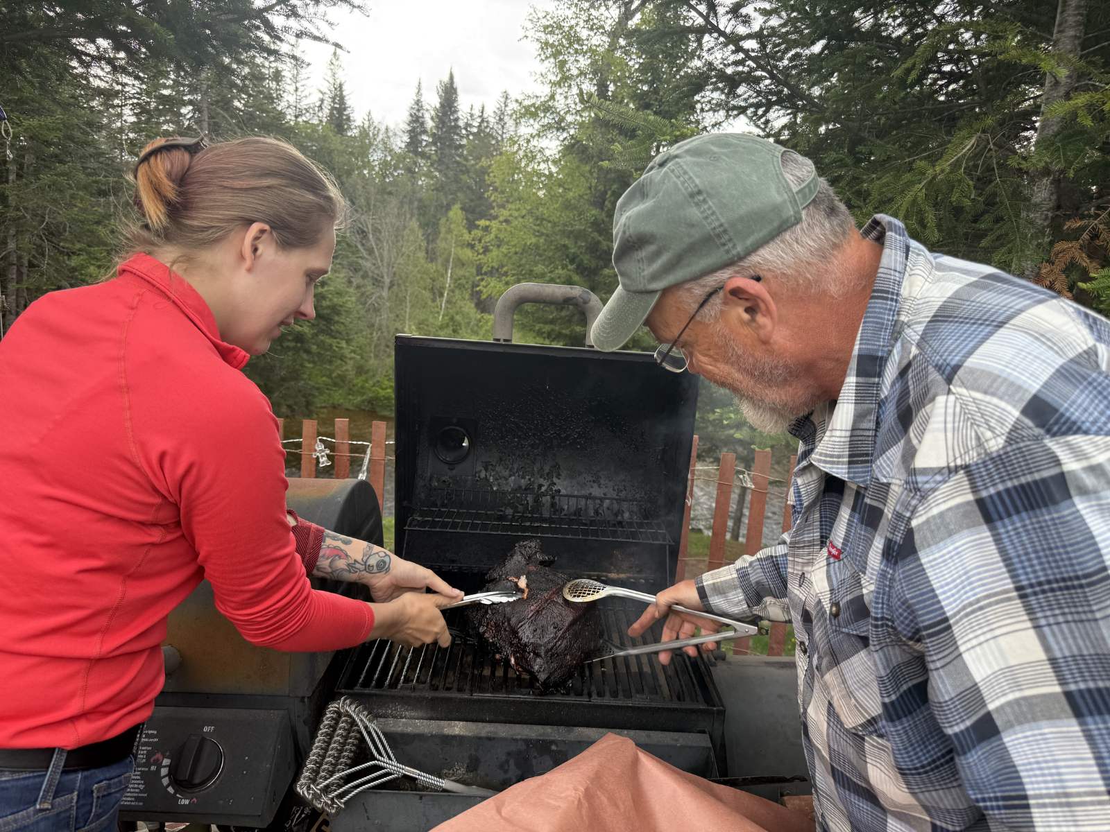 Sam and Rick working the smoker together