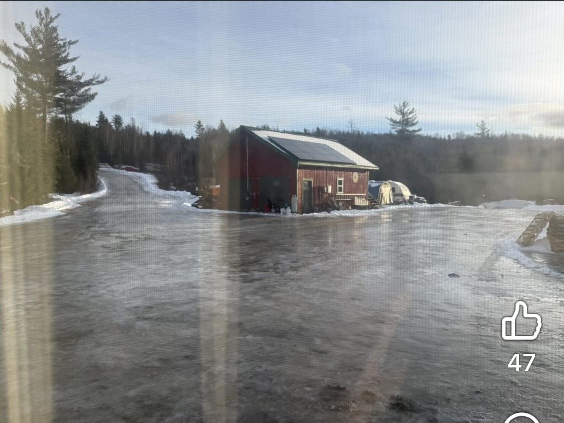 Farm yard and gravel drive completely covered in winter ice