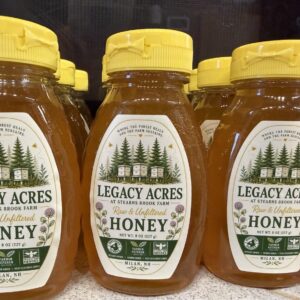 Legacy Acres raw and unfiltered honey in yellow-capped squeeze bottles